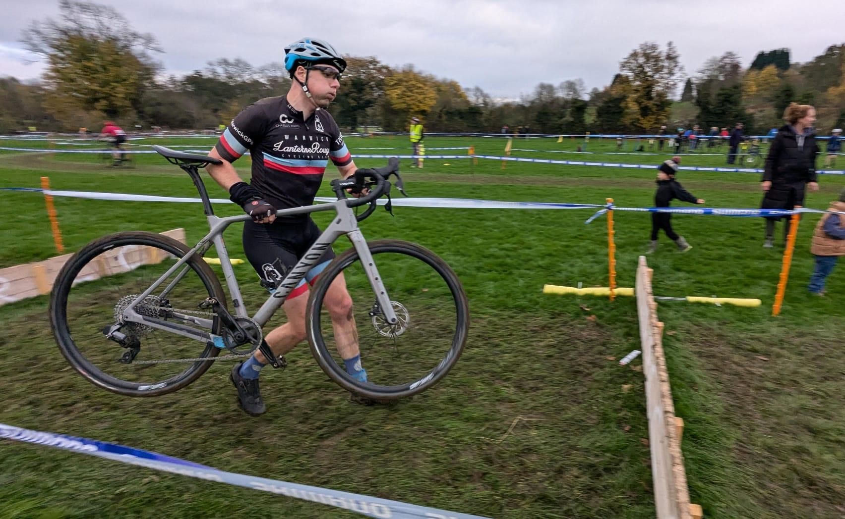 carrying a bike over wooden boards