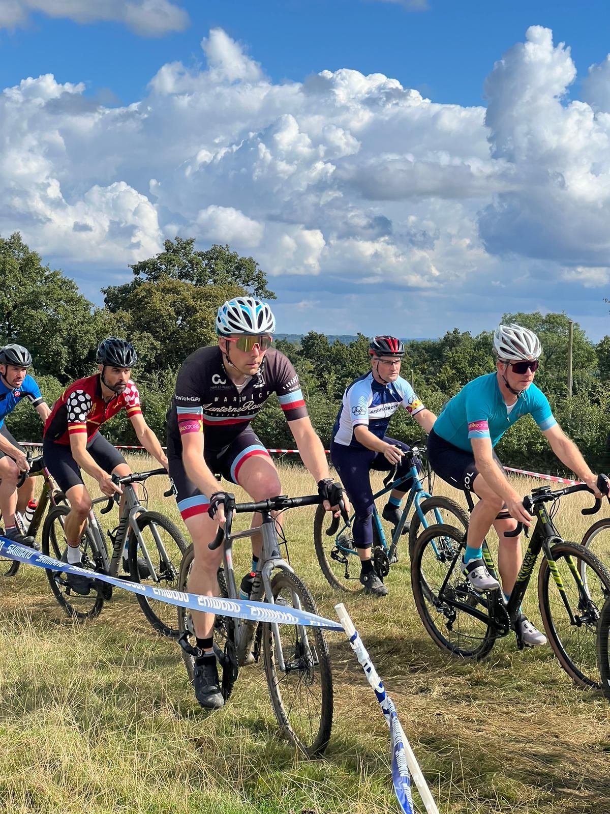 4 men in a CX race on grass